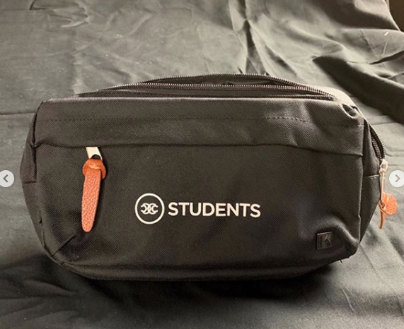 Customer photo from Sarah of our Kapston Jaxon Travel Pack, a black bag with white text on it